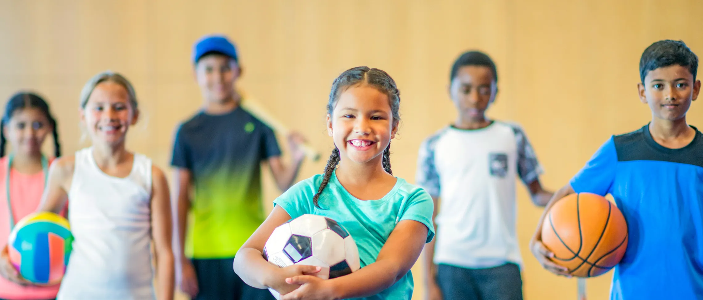 kids with multiple sports items