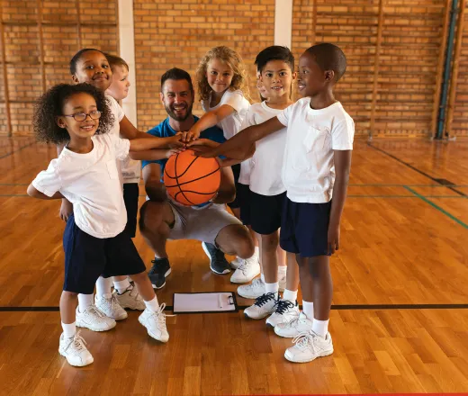 kids basketball team with coach